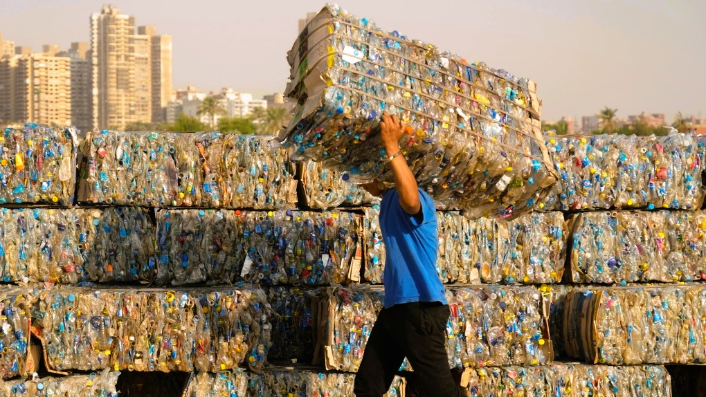 The guy carries a bale of plastic